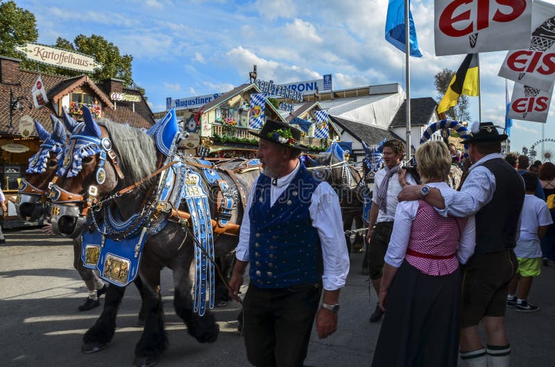 People dressed in traditional bavarian clothes. Thousands people drinking good beer on the traditional Oktoberfest in Munich. People dressed in traditional bavarian clothes. Thousands people drinking good beer on the traditional Oktoberfest in Munich