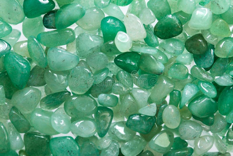 Small stones of green aventurine. Ornamental stone in the form of fine-grained pebbles. Healing stone in folk medicine and astrology. Small stones of green aventurine. Ornamental stone in the form of fine-grained pebbles. Healing stone in folk medicine and astrology
