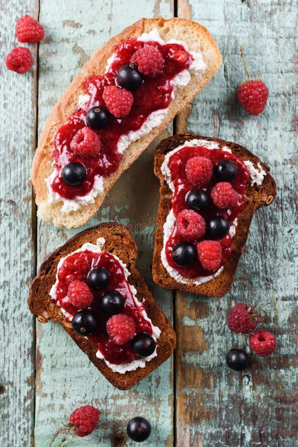 Desayuno rápido, atasco en tostadas Atasco de frambuesa, ricotta y b crudo fotos de archivo libres de regalías Desayuno rápido, atasco en tostadas Atasco de frambuesa, ricotta y b crudo fotos de archivo libres de regalías