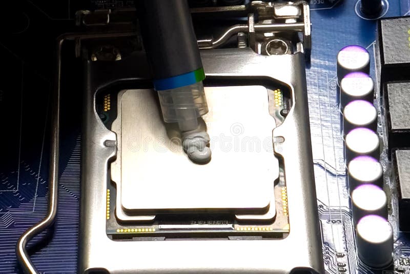 Drawing thermal paste on the computer processor. Installing a cooling system on a CPU processor. Drawing thermal paste on the computer processor. Installing a cooling system on a CPU processor