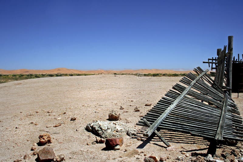 Desert landscape with broken wooden picket fence royalty free stock photo