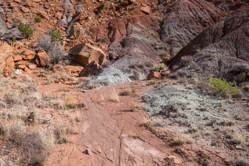 Desert landscape of a dry streambed of cracked earth below a colorful mountainside stock photos Desert landscape of a dry streambed of cracked earth below a colorful mountainside stock photos