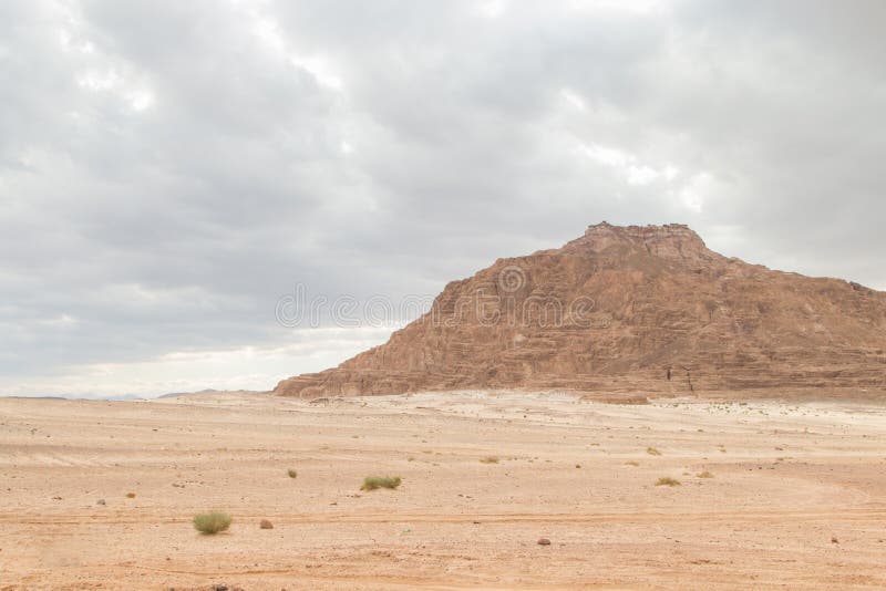 Desert, red mountains, rocks and cloudy sky. Egypt, color canyon