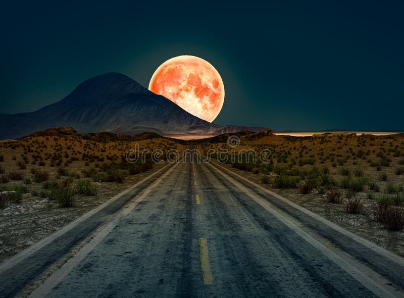 A desert road at night leading off into infinity with a huge full moon. On the horizon