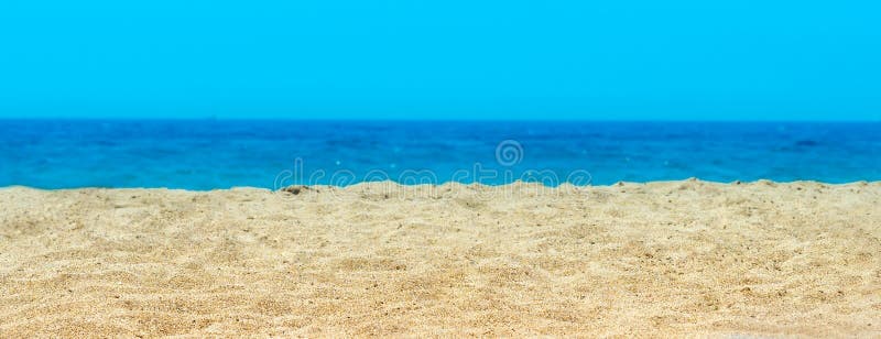 Deserted lonely sandy beach with yellow sand on sea ocean