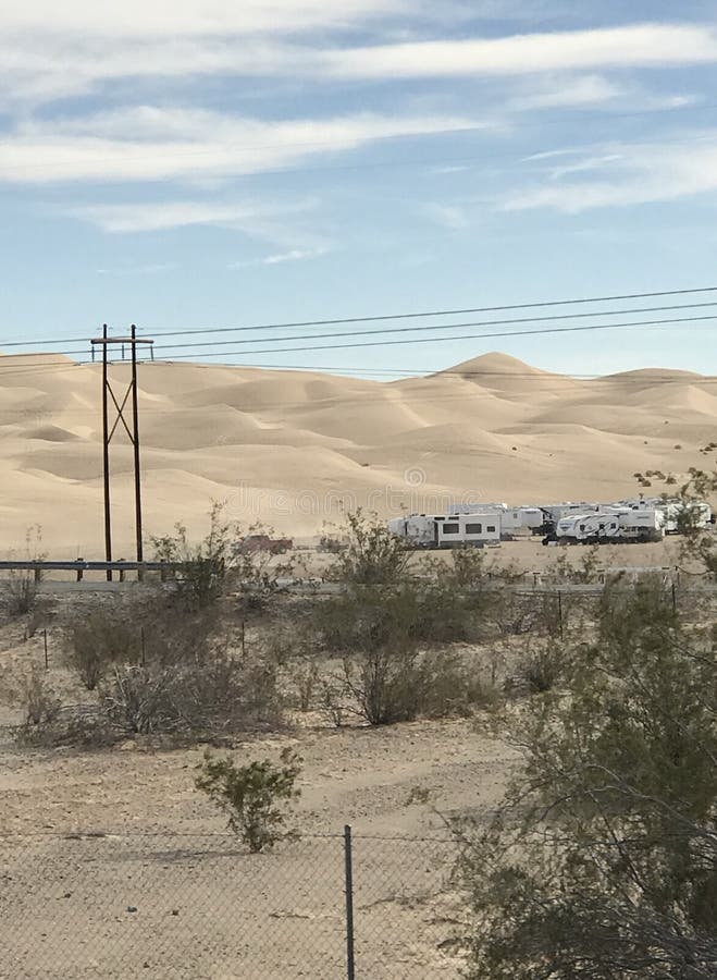 Campers and off roaders in the sand dunes between San Diego California and Yuma Arizona, in the middle of the desert highway between the two states in south United States.  Rough, rocky terrain, sparse vegetation. Campers and off roaders in the sand dunes between San Diego California and Yuma Arizona, in the middle of the desert highway between the two states in south United States.  Rough, rocky terrain, sparse vegetation.