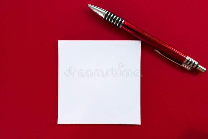 Design concept - Top view of a crayon pen and paper for notes on a red background. Layout Collections