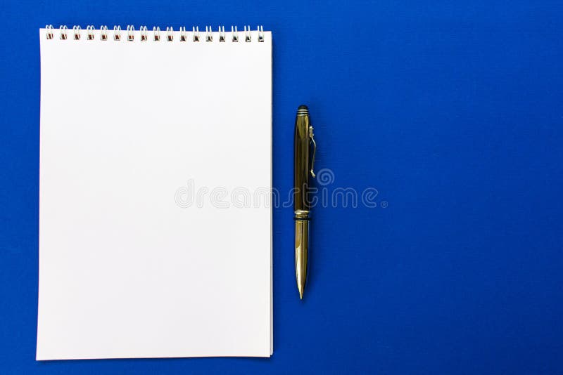 Top view of a spiral school notebook and pens collection on a blue background for layout royalty free stock photography Top view of a spiral school notebook and pens collection on a blue background for layout royalty free stock photography
