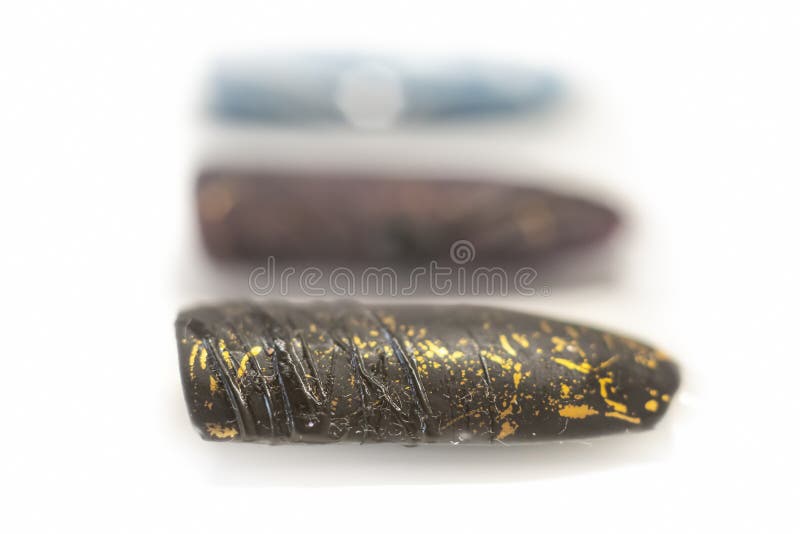 Black matte nail design. Modern 3D effect with spider gel, golden aluminium foil and creative pattern. Selective focus on the details, object isolated on white background. Black matte nail design. Modern 3D effect with spider gel, golden aluminium foil and creative pattern. Selective focus on the details, object isolated on white background.