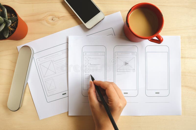 Designer drawing mobile application wireframe stock photography