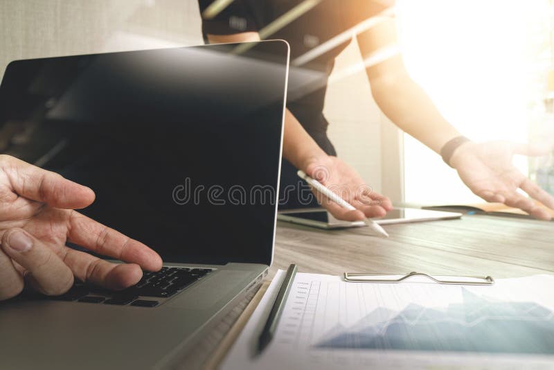 Designer hand working with digital tablet computer and smart phone on wooden desk as responsive web design concept royalty free stock photo Designer hand working with digital tablet computer and smart phone on wooden desk as responsive web design concept royalty free stock photo