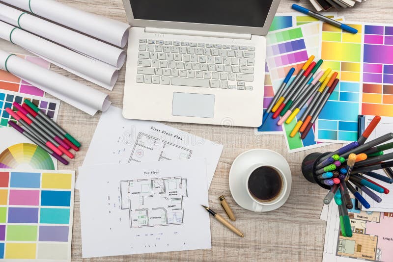 Designer`s workplace top view. House plan with colorful palettes, laptop and cup of coffee