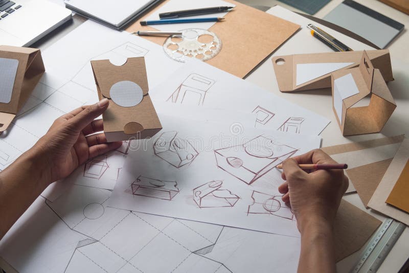 Designer sketching drawing design Brown craft cardboard paper product eco packaging mockup box development template package branding Label . designer studio concept