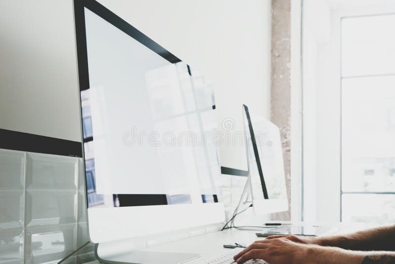 Designer working at workspace with generic design computer on the table. Blank screen desktop. Horizontal mockup stock photography