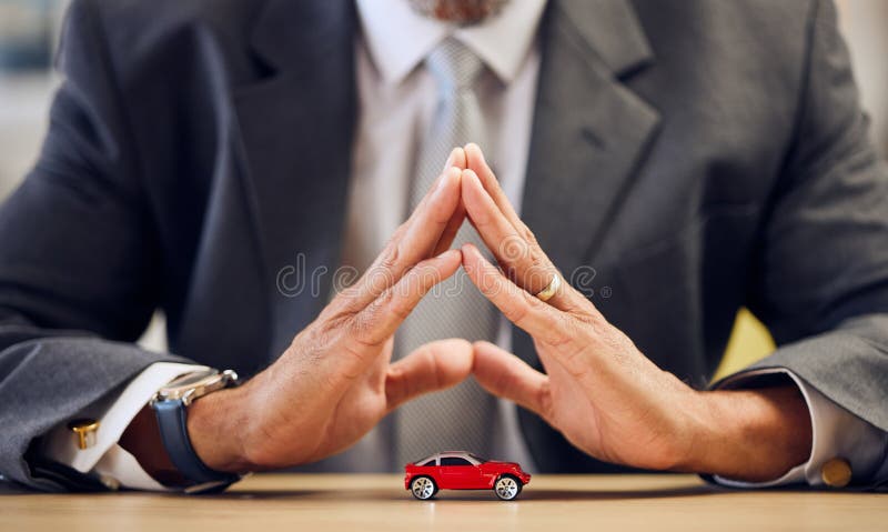 Desk, hands and a person covering for car insurance, investment and auto support. Table, corporate and a businessman with security or safety of transportation for a guarantee or premium service.