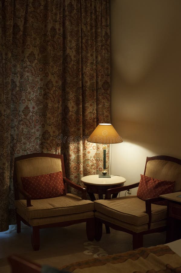 Desk lamp and two chairs in the room of hotel royalty free stock photo Desk lamp and two chairs in the room of hotel royalty free stock photo