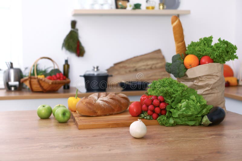 Desk with many fresh vegetables and fruits in the kitchen. Cooking, vegetarian and shopping concept.