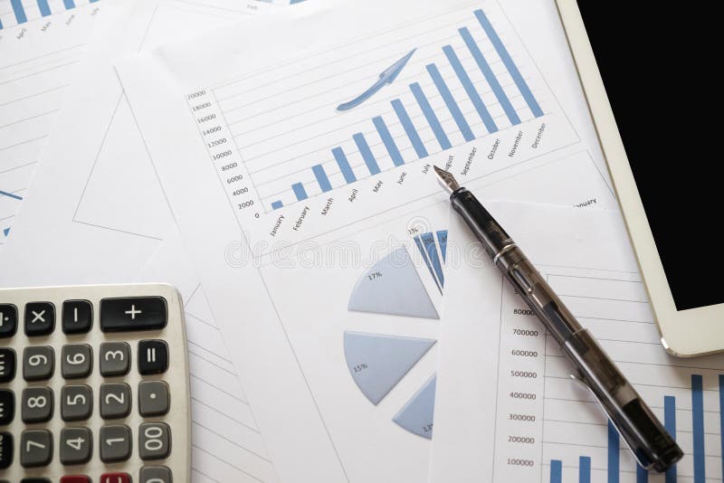 Desk Office with Analysis Report ,calculator. View from Top. Co Stock