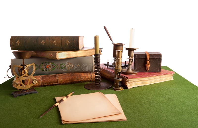 Desk with an open book and old stationery. Isolate