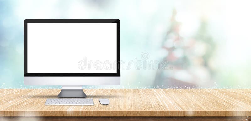 Desktop del computer dello schermo in bianco sulla tavola di legno con sfuocatura astratta immagine stock