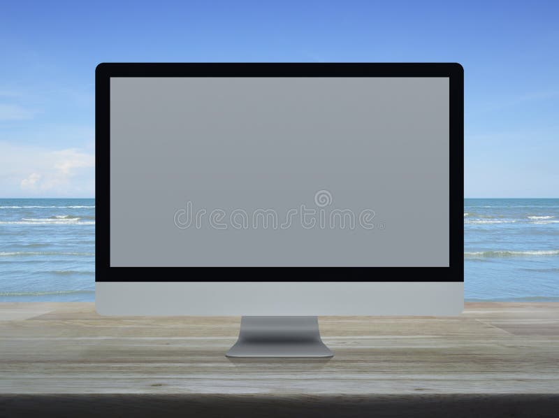 Desktop nowożytny komputerowy monitor z białym szerokim ekranem na drewnianym zdjęcie stock Desktop nowożytny komputerowy monitor z białym szerokim ekranem na drewnianym zdjęcie stock
