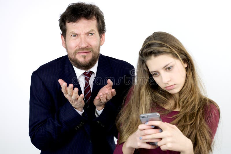 Desperate father with daughter addicted to cell phone stock photo Desperate father with daughter addicted to cell phone stock photo