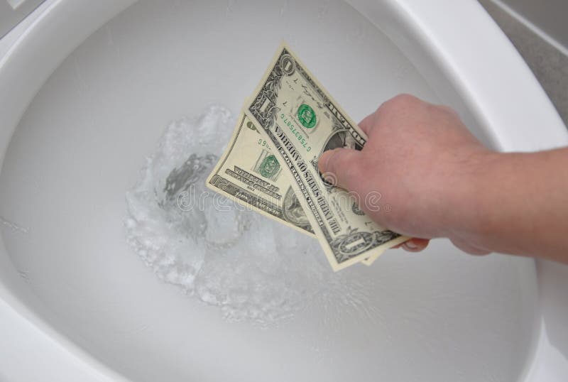 Close up human hand drop money down to the toilet. Close up human hand drop money down to the toilet