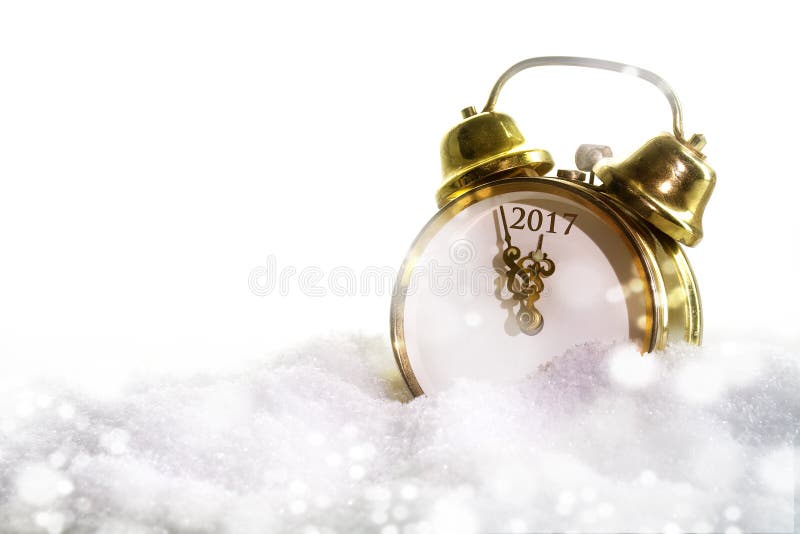 New year alarm clock in the snow showing 2017, white background with copy space. New year alarm clock in the snow showing 2017, white background with copy space