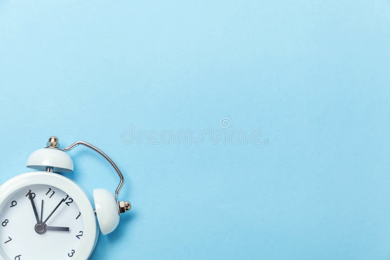 Ringing twin bell vintage classic alarm clock Isolated on blue pastel colorful trendy background. Rest hours time of life good morning night wake up awake concept. Flat lay top view copy space. Ringing twin bell vintage classic alarm clock Isolated on blue pastel colorful trendy background. Rest hours time of life good morning night wake up awake concept. Flat lay top view copy space