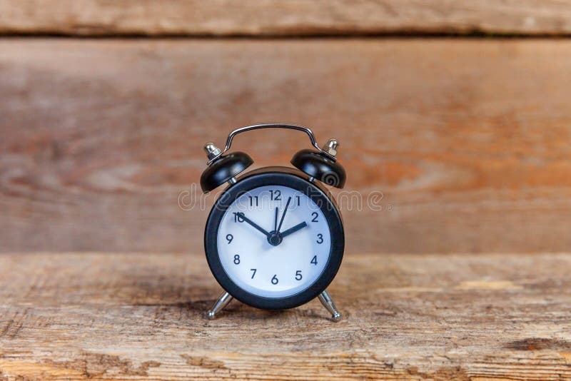 Ringing twin bell vintage classic alarm clock on old shabby rustic wooden background. Rest hours, time of life, good morning night, wake up, awake concept. Copy space. Ringing twin bell vintage classic alarm clock on old shabby rustic wooden background. Rest hours, time of life, good morning night, wake up, awake concept. Copy space