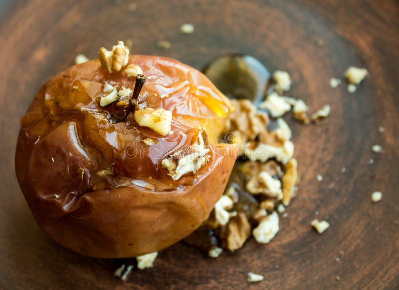 Dessert with Baked Apple of Honey and Nuts on a Clay Plate Stock Image ...