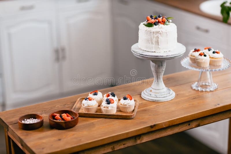 Dessert cake on kitchen table. Cakes cupcakes and sweet dessert. stock photos