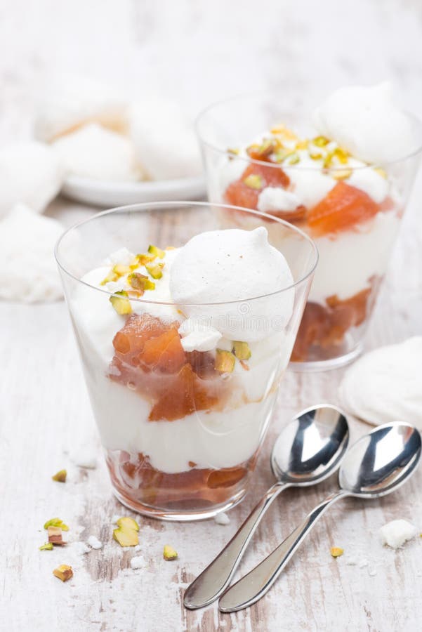 Dessert with canned peaches, whipped cream, meringue, vertical