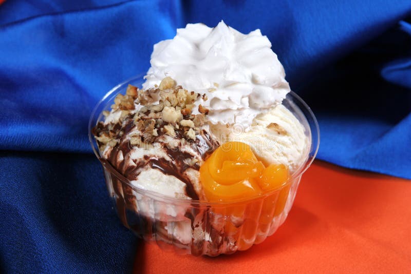 Dessert of Ice Cream and Cream Covered in Chocolate with Nuts Stock