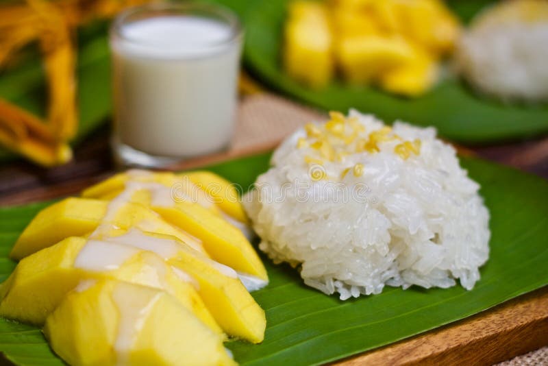 Dessert sweet sticky rice with mango coconut milk on banana tree