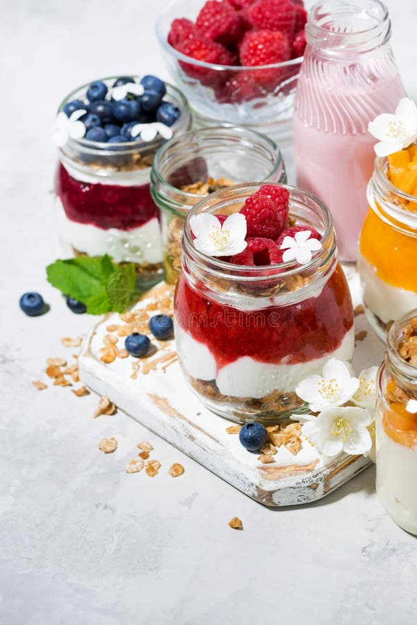 Desserts with Muesli, Berries and Fruit in Jars, Vertical Stock Photo