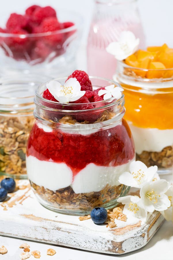 Desserts with Muesli, Fresh Berries and Fruit in Jars, Vertical Closeup