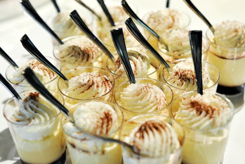 Close-up of mouth watering Desserts in small glasses with spoon.