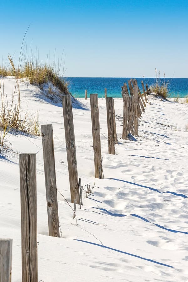 Sand dune and old fence along a beach in Destin, Florida. Sand dune and old fence along a beach in Destin, Florida