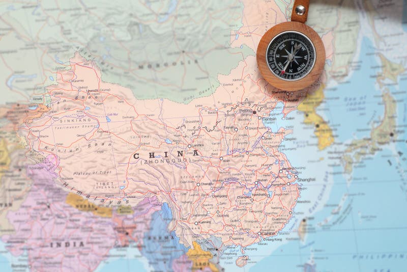 Compass on a map pointing at China and planning a travel destination. Compass on a map pointing at China and planning a travel destination