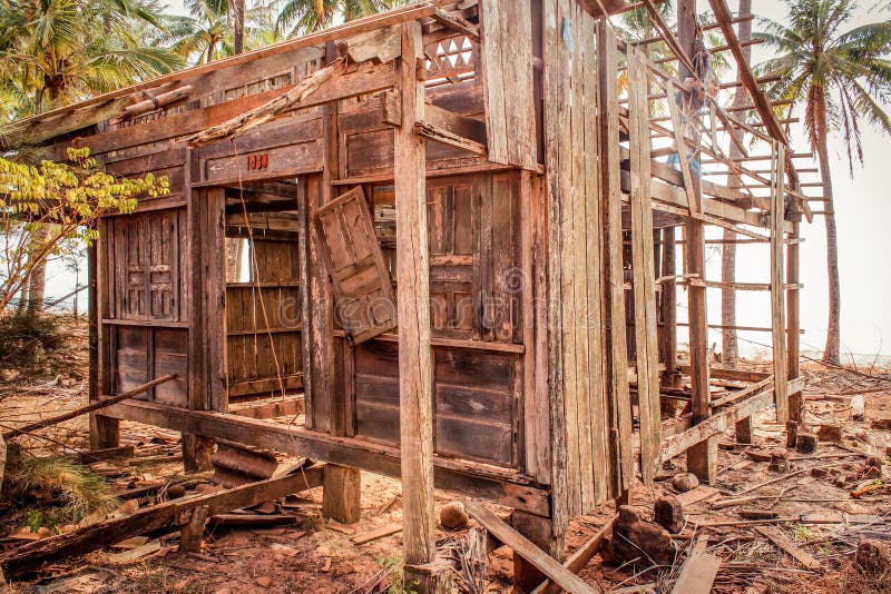 Destroyed home at coast , wooden hut ruin / destroyed house made of wood