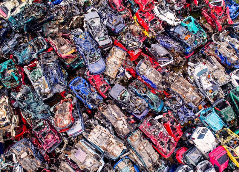 Destroyed scrapped cars stacked on a scrap yard. Car recycling