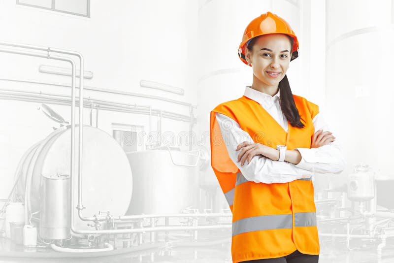 Destroying gender stereotypes. Female builder standing against industrial background. Destroying gender stereotypes. Female builder in orange helmet standing royalty free stock photo Destroying gender stereotypes. Female builder standing against industrial background. Destroying gender stereotypes. Female builder in orange helmet standing royalty free stock photo