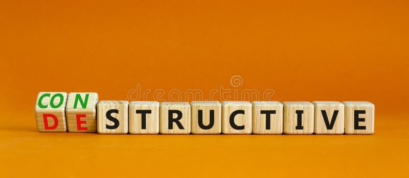 Destructive or constructive symbol. Turned wooden cubes and changed the concept word Destructive to Constructive. Beautiful orange