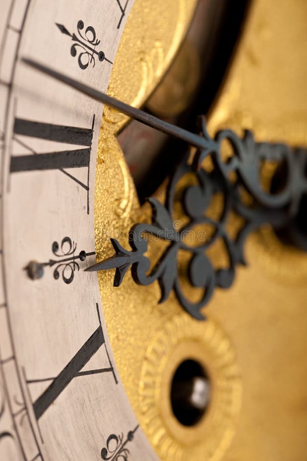 Detail of antique clock with Roman numeral stock images