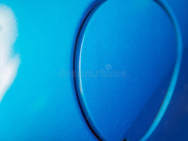 Detail of automobile fuel door close up metallic blue car paint texture