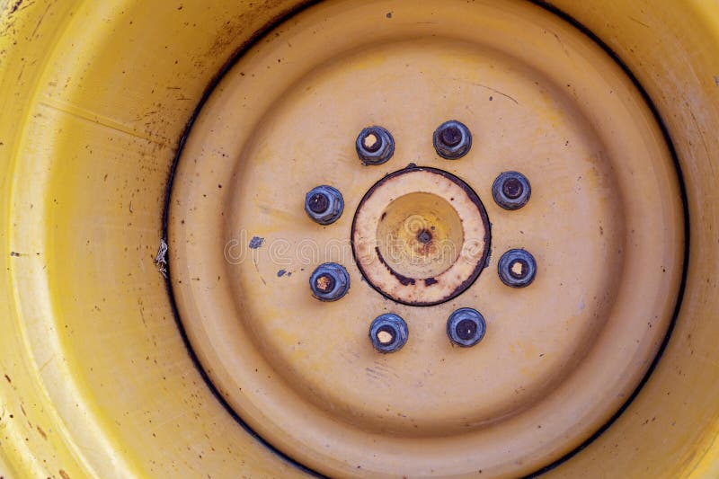 Detail of the bolts on the rim of a backhoe wheel royalty free stock photography