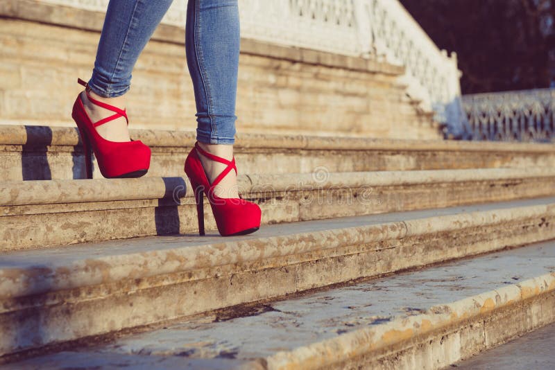 Woman Wearing Blue Jeans and Red High Heel Shoes in Old Town. the Women ...