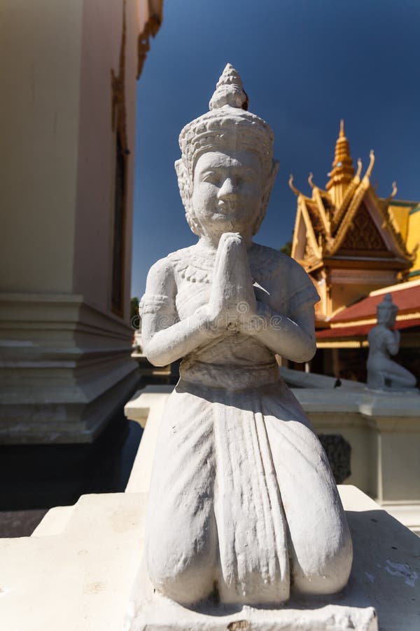 Detail of Closeup of kneeling, praying Buddha statue at the Royal palace phnom Penh