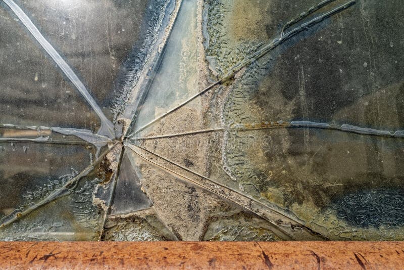 Detail of a crack in the window of an antique panel truck stock photo